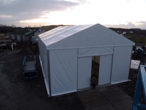 Temporary fabric hall with entrance – front view at dusk