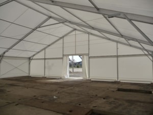 Interior of temporary roofing – wide space with a central gable entrance