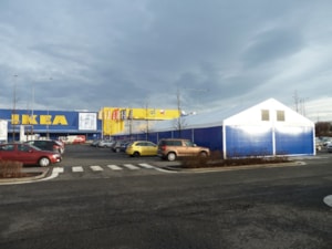 Fabric tent hall at a shopping centre – side view, sales on a paved area