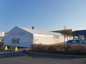 Fabric tent hall by a roundabout – front view of a temporary retail structure