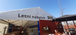 Fabric tent hall by a store – gable end with signage and an open entrance