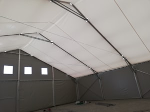 Insulated fabric hall with an inner liner and dark side cladding