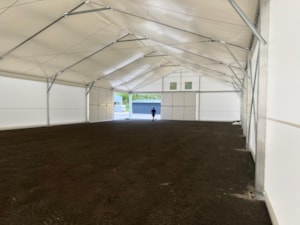 Insulated fabric hall with a long open interior for storage use