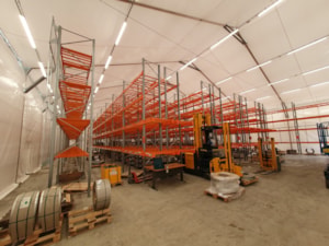 Insulated fabric storage hall with a racking system and handling equipment