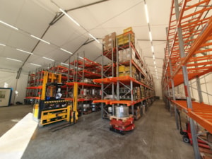 Insulated fabric hall with high racks for storing materials and goods