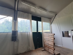 Insulated fabric hall with a door and transparent windows in the wall