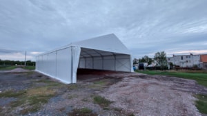 Agricultural tent hall with an open front entrance on a prepared site
