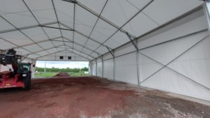 Fabric agricultural hall with interior space for equipment and storage