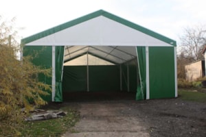 Fabric agricultural hall with an open front entrance for equipment and materials